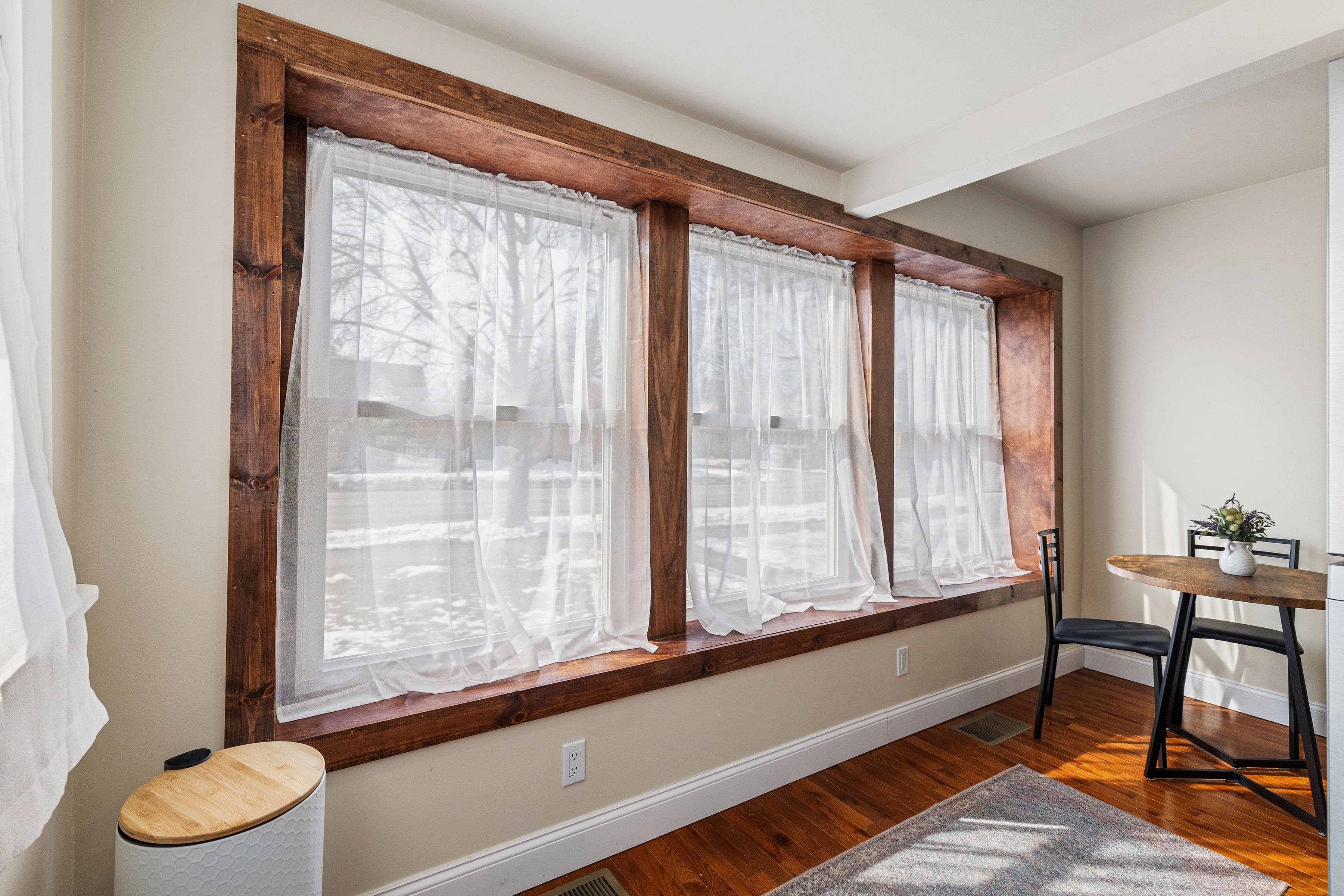 Wood trim around the sunlit bay window